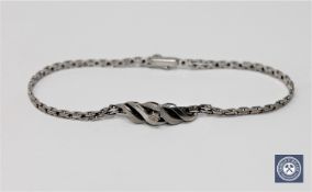 A 9ct white gold bracelet set with a small diamond, 4.9g.