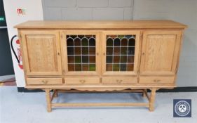 A blond oak leaded glass sideboard