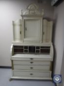 A continental cream and gilt cylinder bureau
