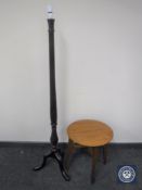 A carved mahogany standard lamp on tripod base together with a circular oak occasional table