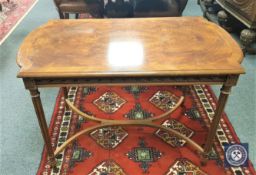 A burr walnut side table with curved under stretcher, width 110 cm.