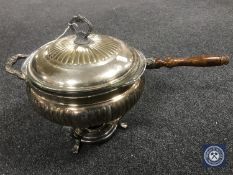 An antique silver plated long handled chafing dish with glass liner,