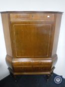 A continental mahogany corner cabinet
