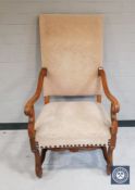 A carved beech framed continental scroll armchair