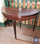 A mahogany demi-lune foldover top table