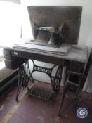 A Singer treadle sewing machine in oak table