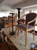 Two circular plant stands and a pair of contemporary armchairs