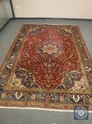 A Kirman carpet, on red ground,