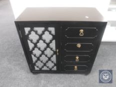 A mirror door cabinet fitted four drawers