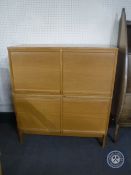 A 20th century office four door shutter front stationary cabinet