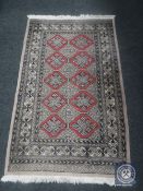 A Bokhara design rug on peach ground,