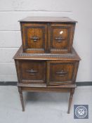 An Edwardian oak cupboard on stand
