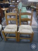 A pair of pine rush seated ladder back kitchen chairs