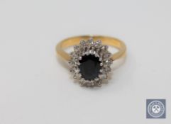 An 18ct gold sapphire and diamond cluster ring,