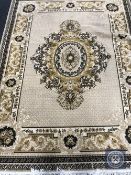 A circular fringed floral rug together with one other