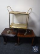 A nest of three mahogany G-Plan tables together with a walnut table and a gilt two tier tea trolley