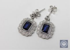 A pair of 14ct white gold sapphire and diamond earrings featuring 2 cushion cut sapphires 2.