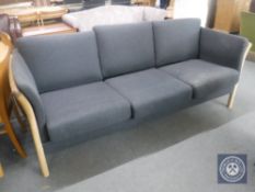 A 20th century wooden framed settee upholstered in a black fabric