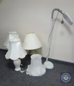 A brass table lamp with shade together with two other table lamps with shades and angle poised