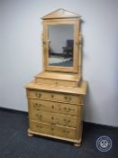 An antique pine four drawer dressing chest on bun feet
