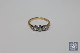 An 18ct gold three stone diamond ring, the central stone approximately 0.5ct, total approximately 1.