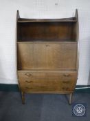 A mid 20th century Danish teak writing bureau fitted shelf above and three drawers beneath