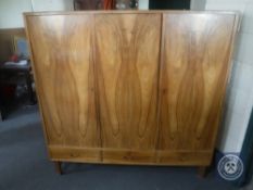 A mid 20th century Danish triple door sideboard fitted drawers beneath