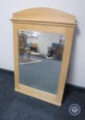 An early 20th century pine framed bevelled mirror