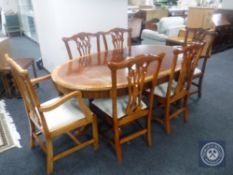 An oval inlaid mahogany twin pedestal dining table with leaf together with a set of six Hepplewhite