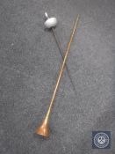 A long copper and brass horn together with a fencing foil