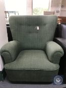 A 1930's button back armchair upholstered in a green fabric