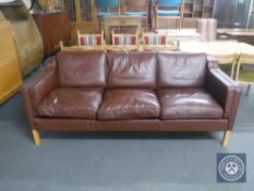 A late 20th century Danish brown leather three seater settee