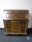 A continental oak serpentine fronted writing bureau