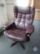 A late 20th century Burgundy leather swivel armchair