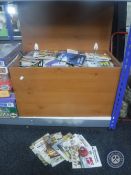 A pine effect blanket box containing a large quantity of Commando pocket comics