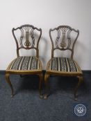 A pair of early 20th century mahogany bedroom chairs on cabriole legs
