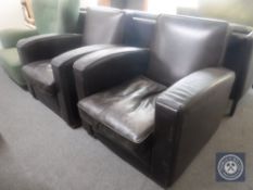 A pair of brown leather club chairs