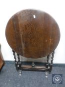 An Edwardian oak barley twist folding table
