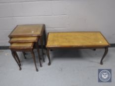 A nest of three mahogany leather topped tables together with matching coffee table