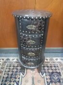 An embossed leather cylindrical four drawer chest