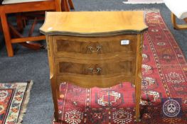 A French inlaid mahogany two drawer bedside chest with ormolu mounts