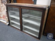 An antique mahogany glazed door bookcase base