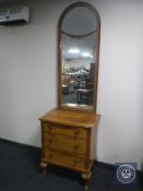A continental walnut three drawer hall chest with dome topped mirror