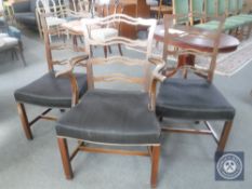 A set of eleven mahogany ladder back dining chairs comprising of one carver and ten singles