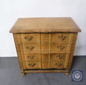 A continental oak shaped-fronted four drawer chest
