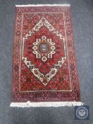 A Tabriz rug, with central rust medallion upon an ivory field of stylised flowers,