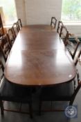 An oval continental oak extending dining table with two leaves