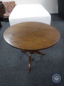 A circular 19th century oak tilt top breakfast table