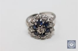 An 18ct white gold diamond and sapphire cluster ring, approximately 0.9ct.