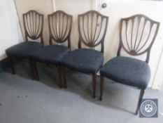 A set of four mahogany shield back dining chairs